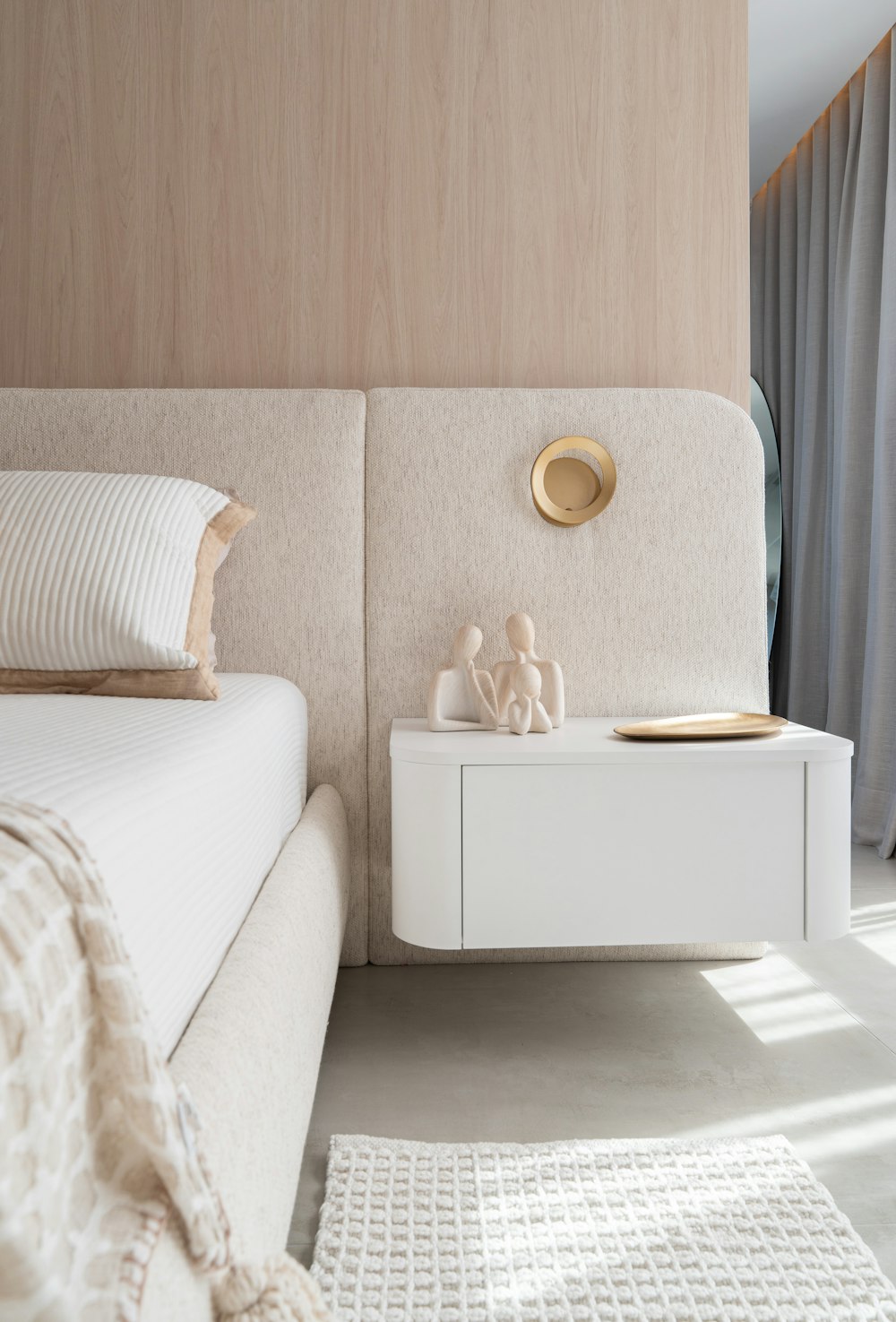 A restful bedroom with a neatly dressed bed and soft natural light